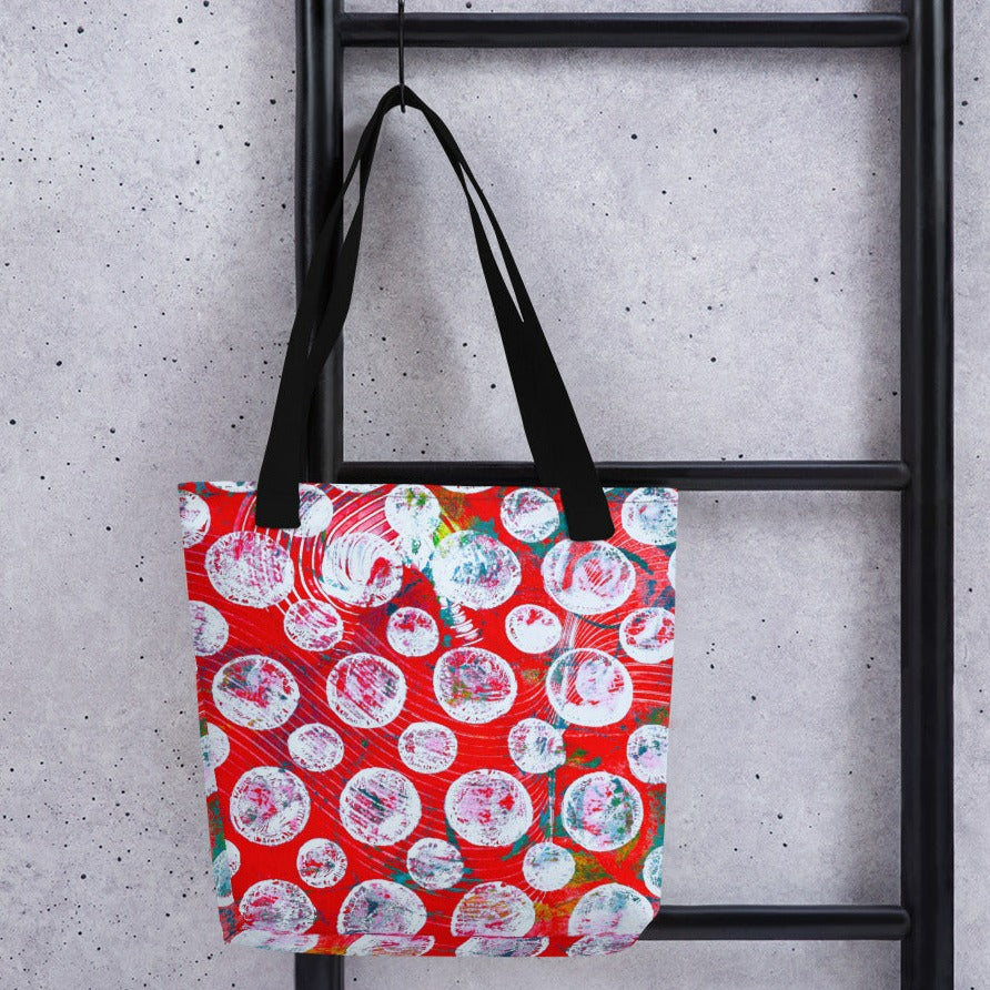 Red tote with white dots and black handles.